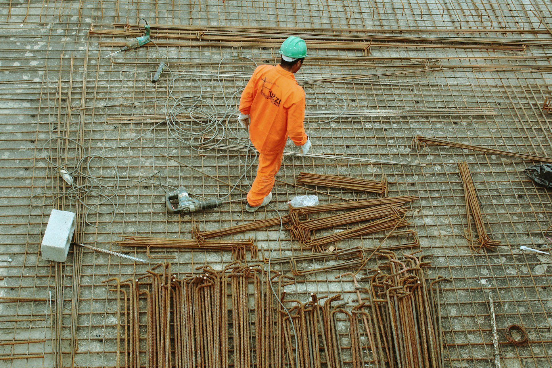 Construction worker surrounded by concrete and rebar